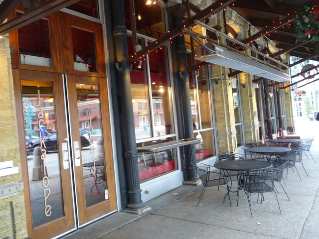 patio-infrared-heaters-hung-from-steel-awning-above-sidewalk